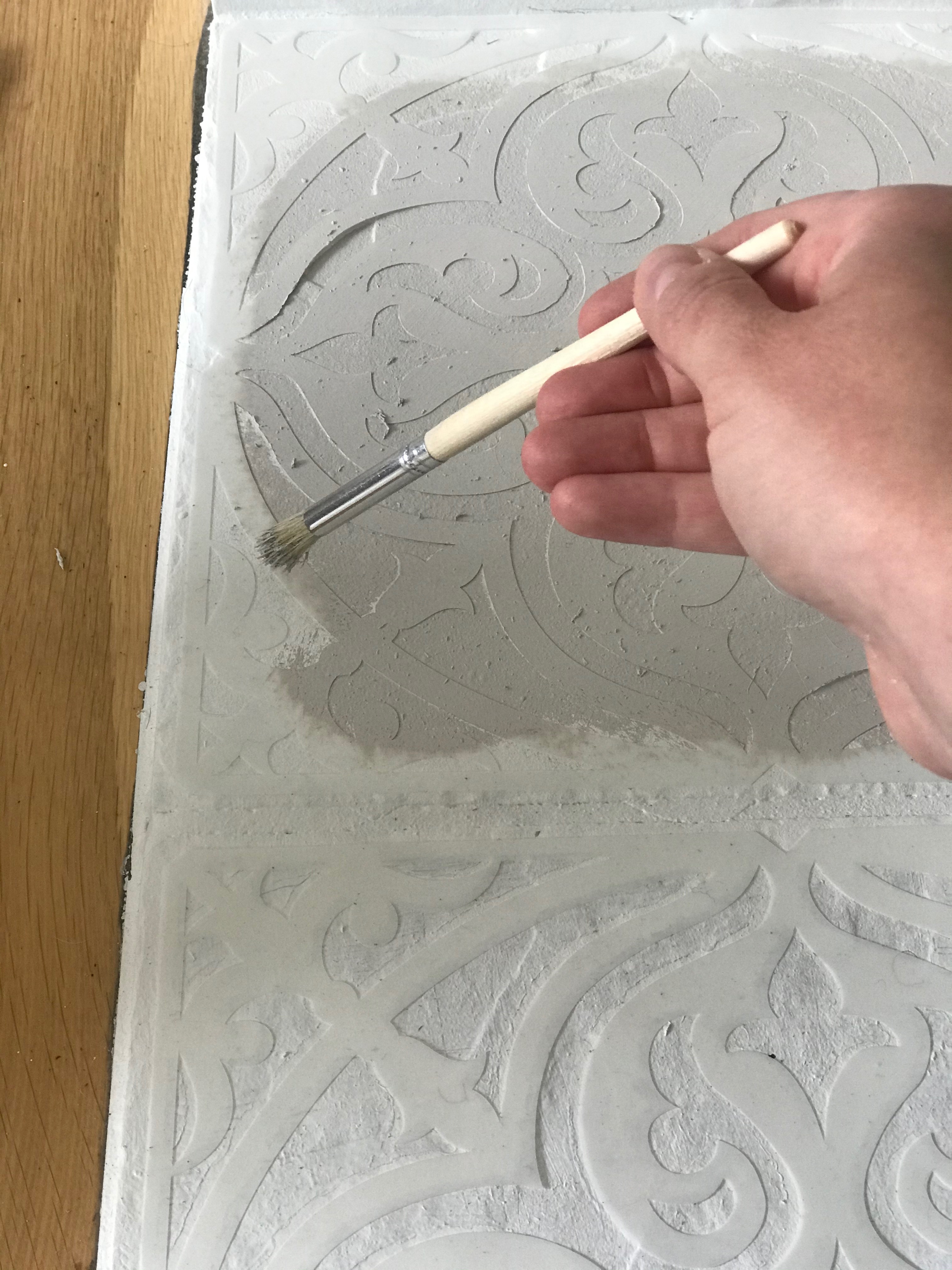 Painting a DIY custom stencil for a fireplace mantel