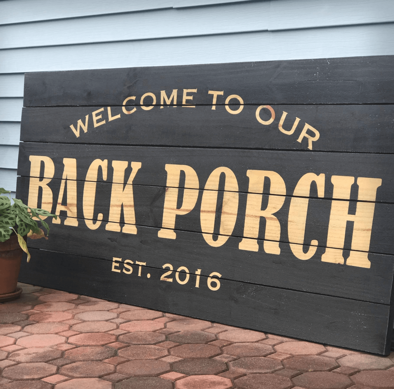 Back porch sign painted with reverse stencil