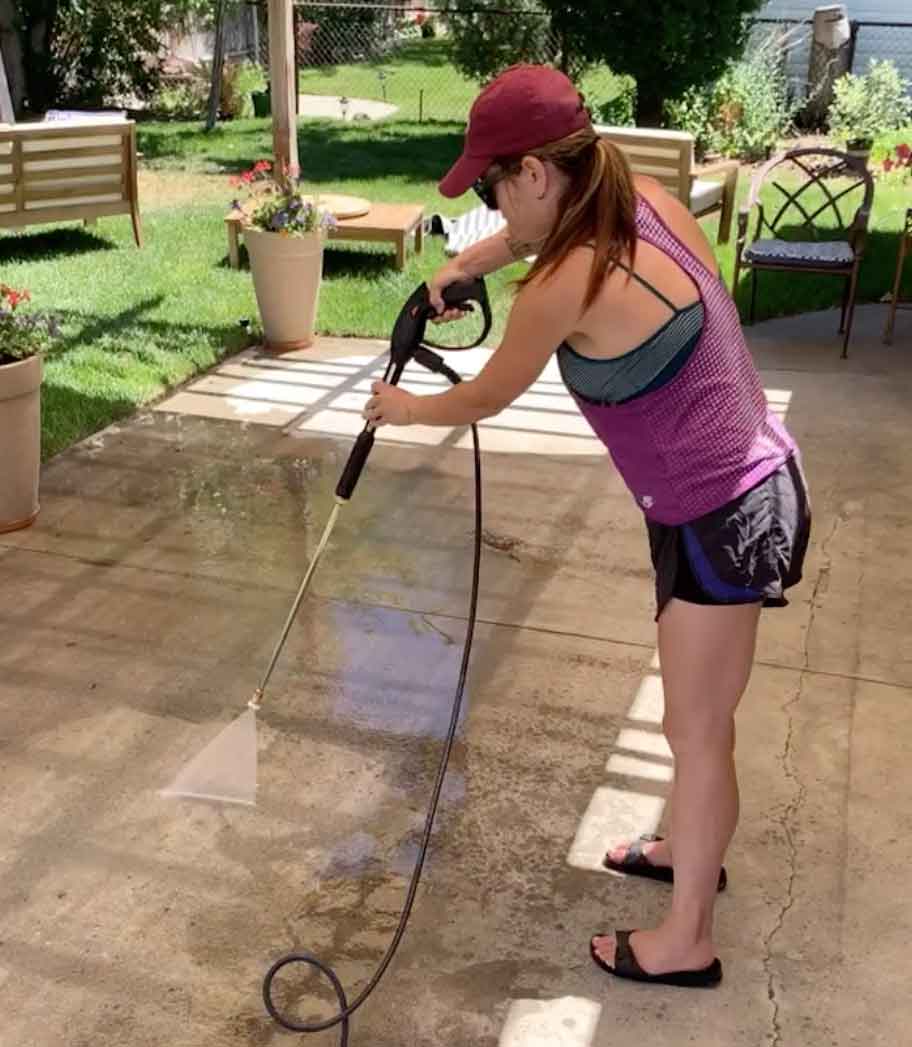 power washing the concrete slab to prep it for paint