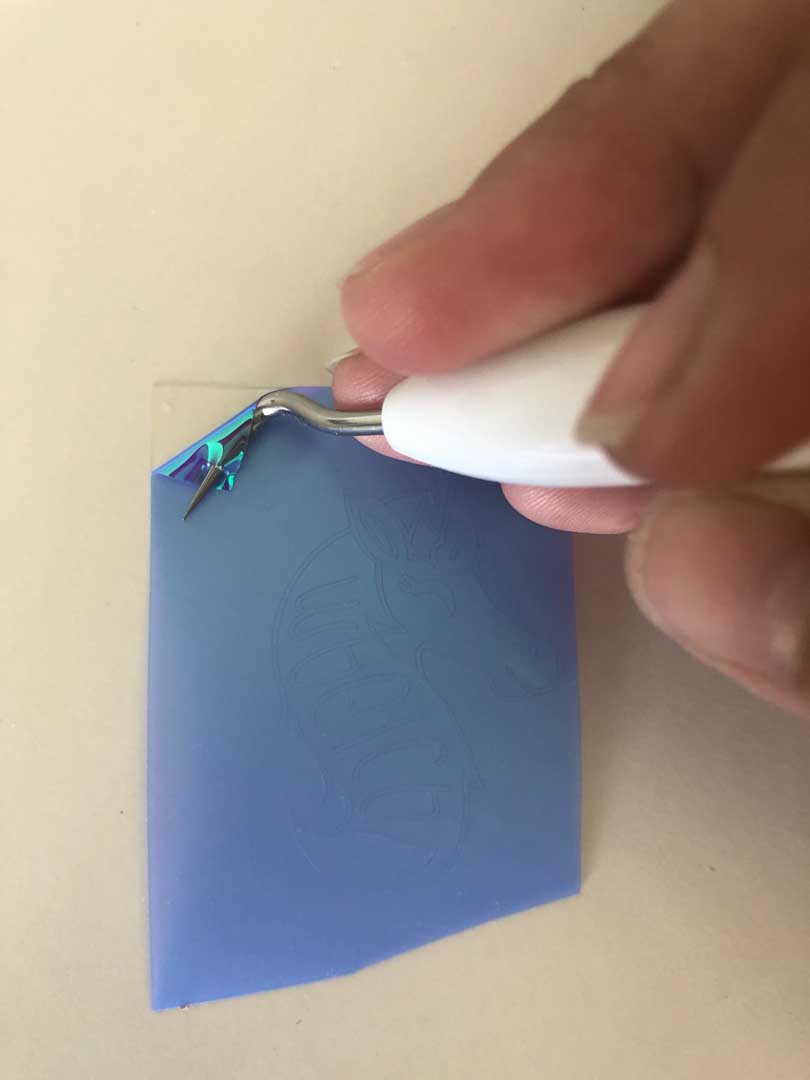 Weeding a unicorn design with Cricut weeding tool