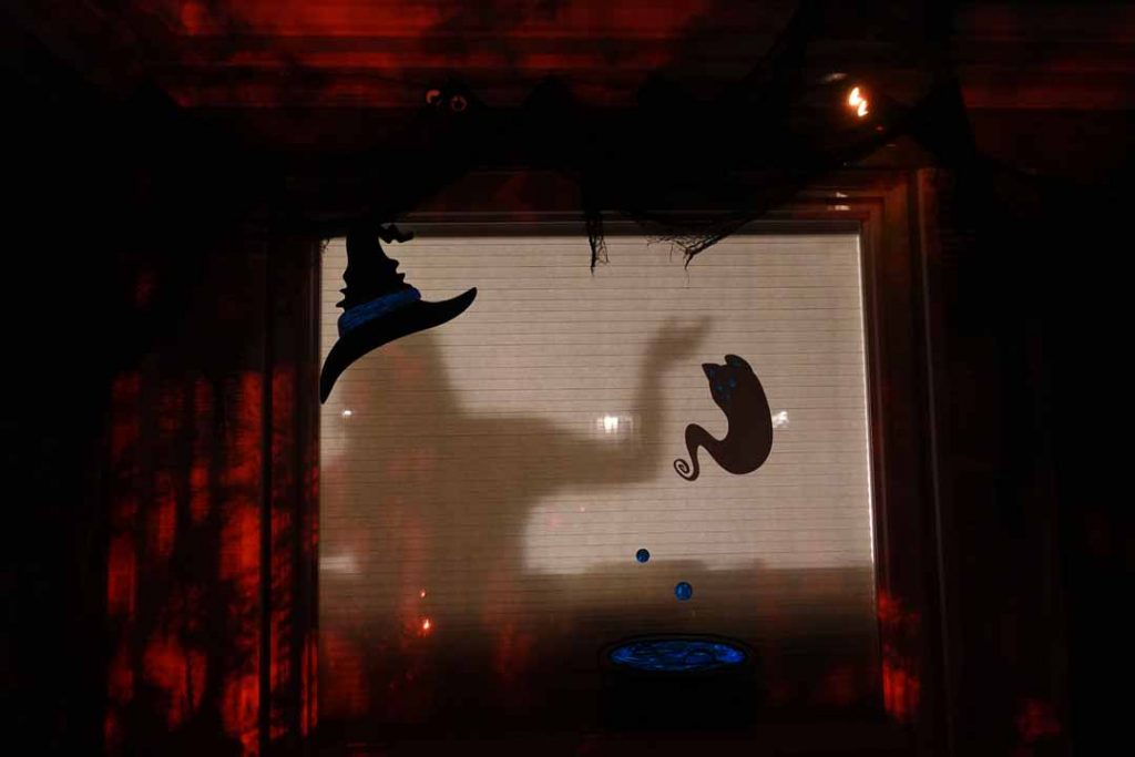 Christi in the window of vinyl silhouettes cut with Cricut Maker