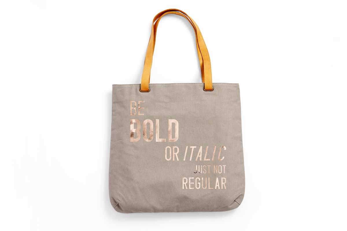 Custom tote with the phrase, "Be bold or italic, just not regular," on it.