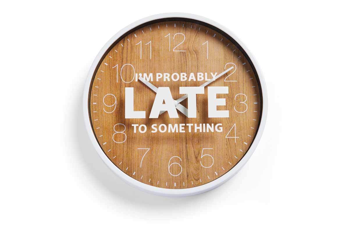 Clock with vinyl phrase saying, "I'm probably late to something."