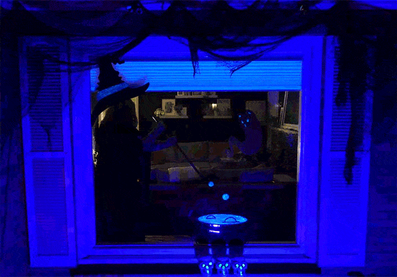 Christi stirring the cauldron in Halloween window silhouettes created by Cricut vinyl