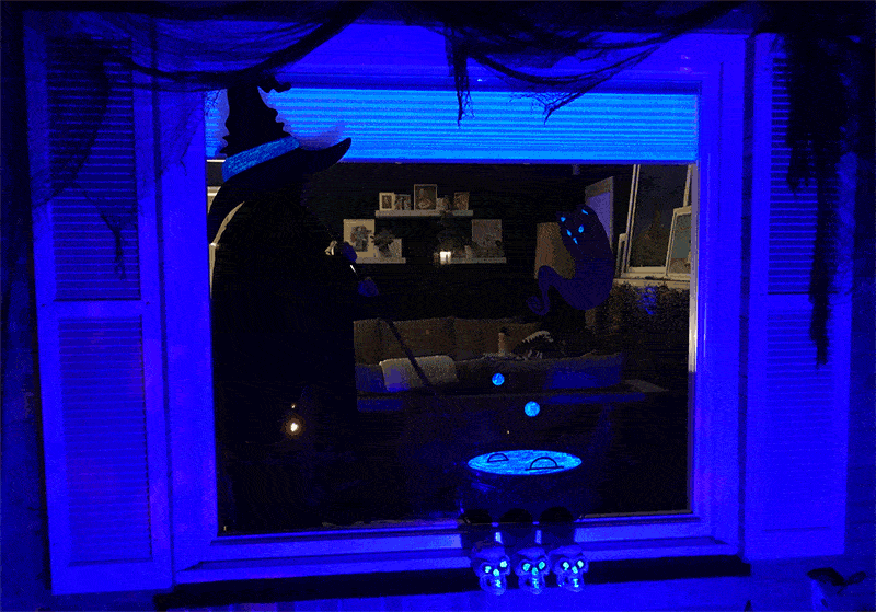 Lansia stirring the cauldron in Halloween window silhouettes created by Cricut vinyl
