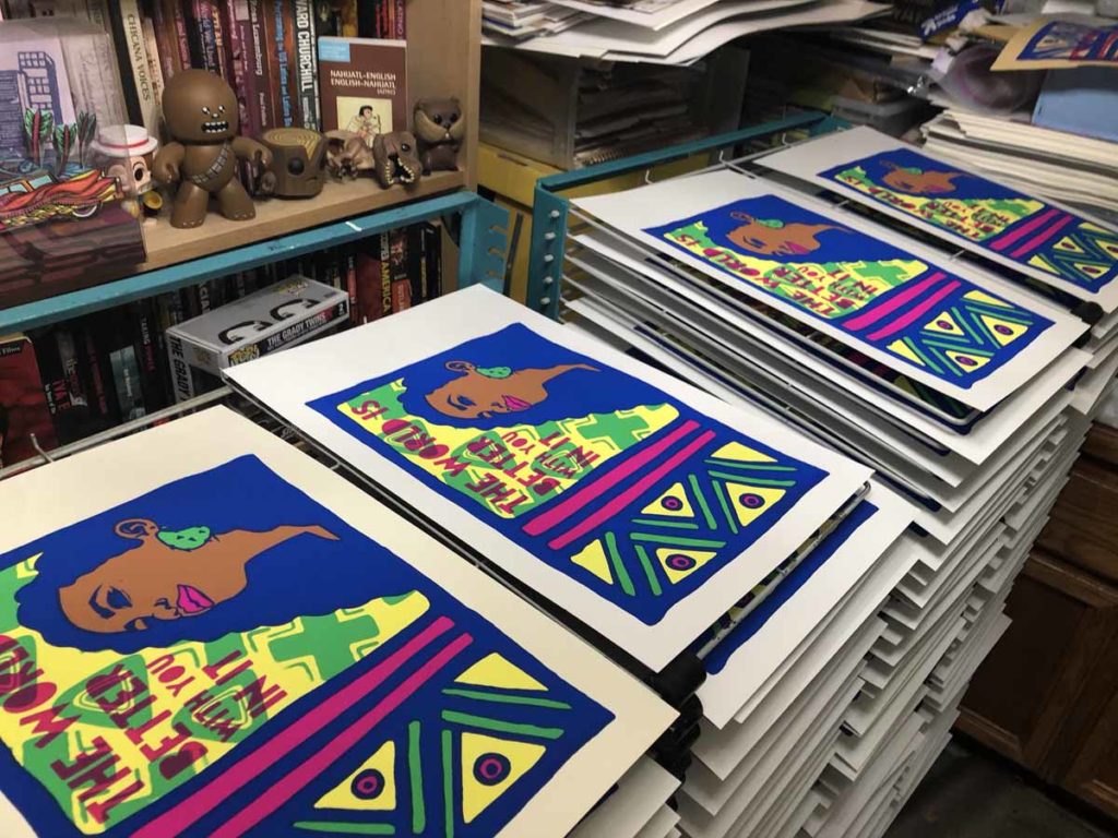 Multiple prints of "Esperanza" from artist Melanie Cervantes drying on racks