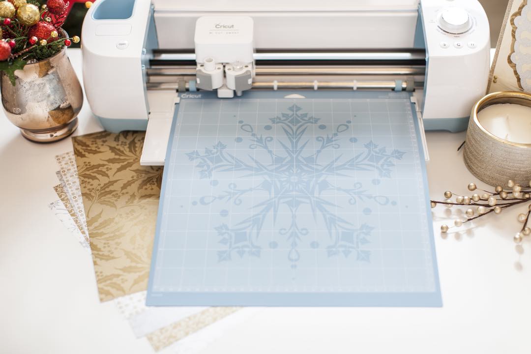 Cricut Maker machine cutting a snowflake with washi paper