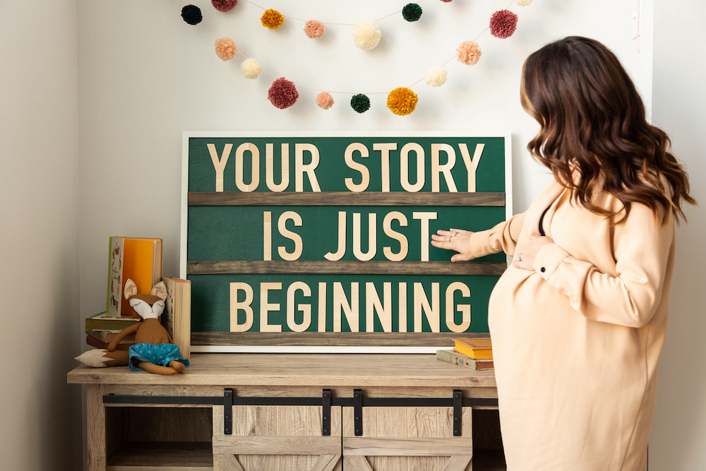 Woman in nursery with sign