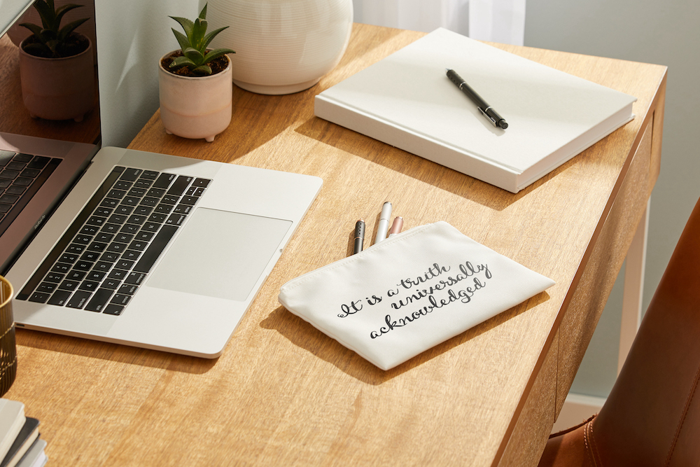 Laptop sitting on desk with pencil case
