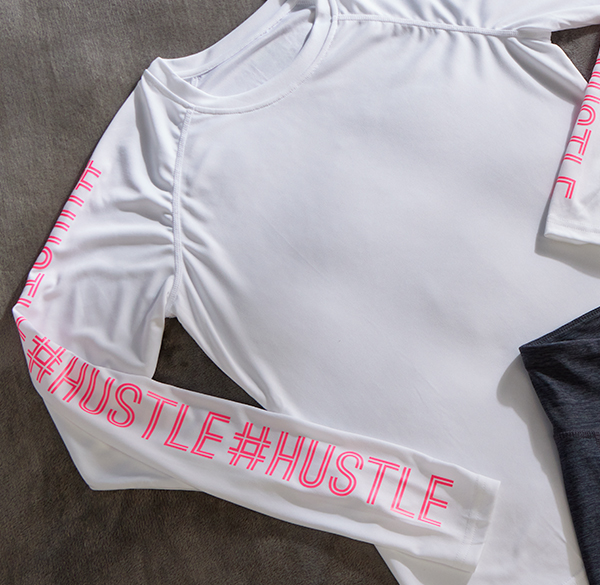 Workout shirt with "hashtag hustle" printed on sleeves