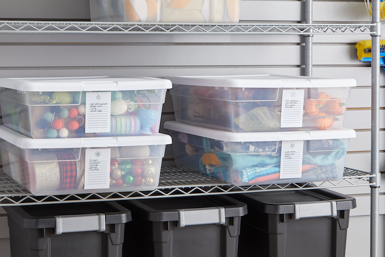 Garage spring cleaning. Seasonal storage bins on a storage shelf.