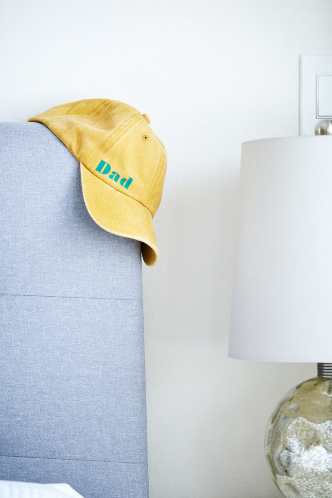 "Dad" hat hanging on side of bed