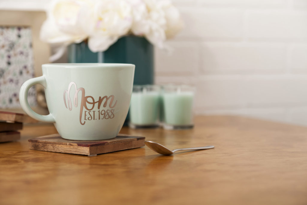 Green mug that reads "Mom est. 1988"