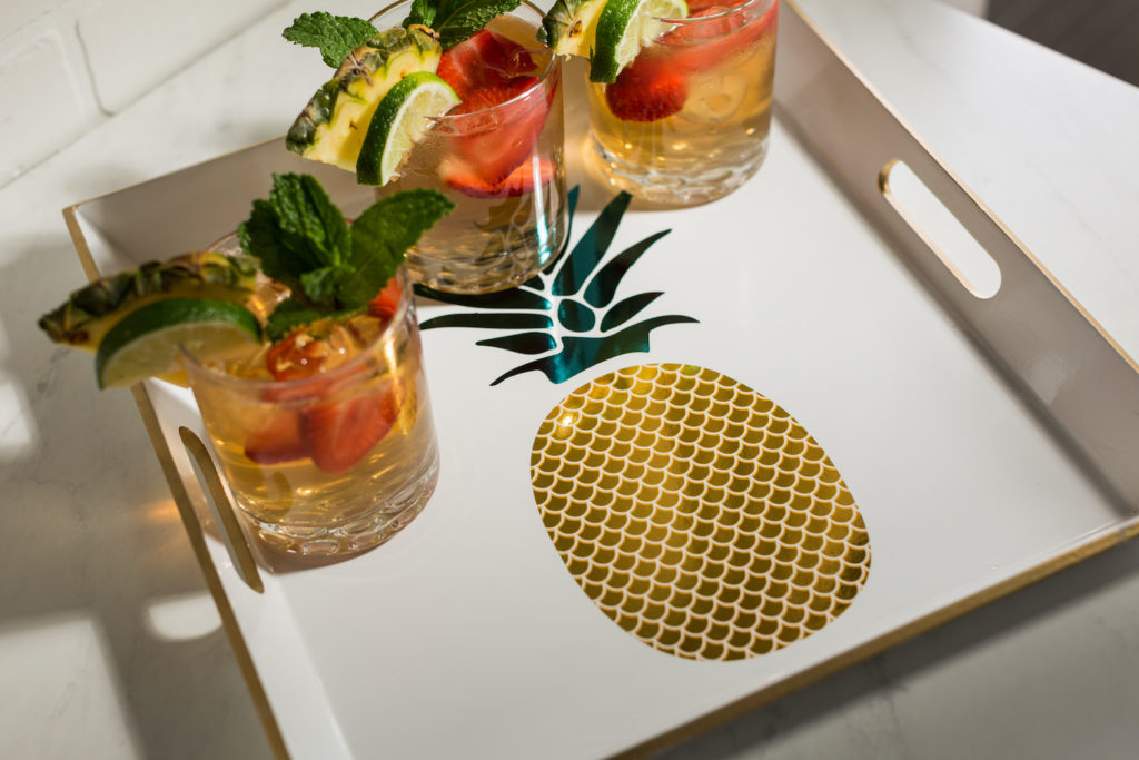 Photo of a drink tray with a golden pineapple on it.