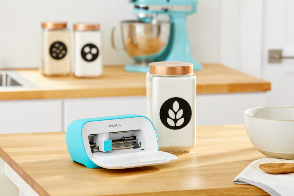 Cricut Joy on countertop with labeled jars