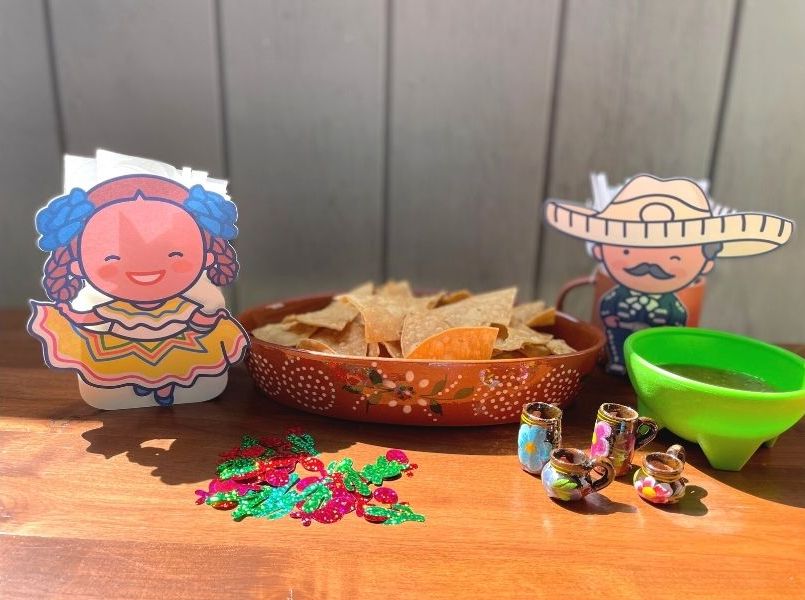 Mariachi and Folklorico girl decorations on table