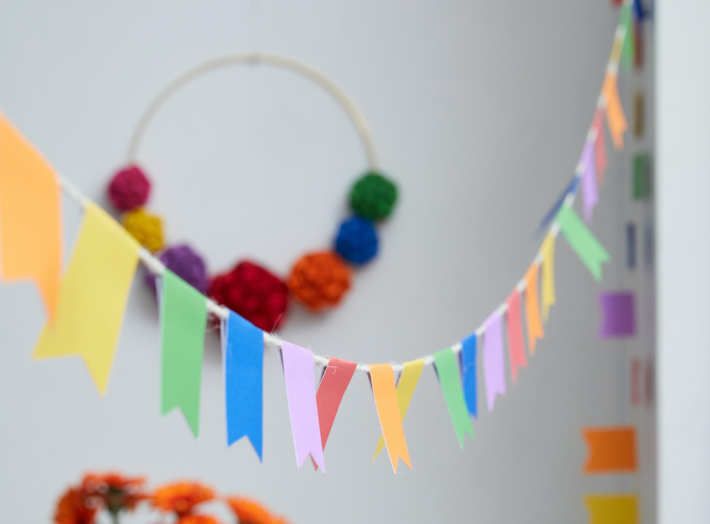 A colorful pennant is hung across a room. 