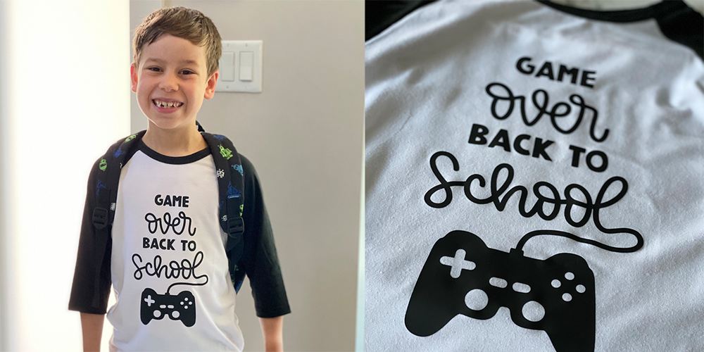 A child proudly wears his Cricut designed back-to-school outfit