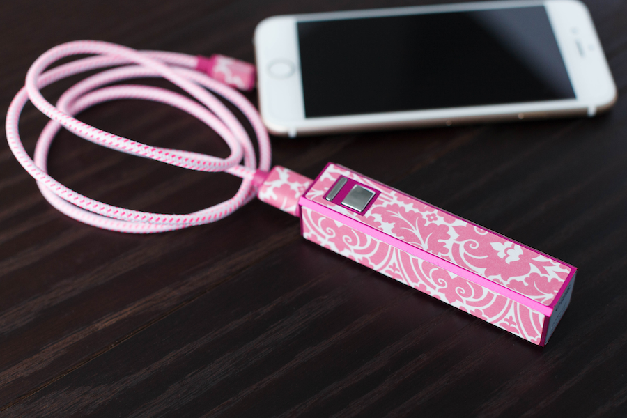 A phone charging bank is covered in a pink floral design 