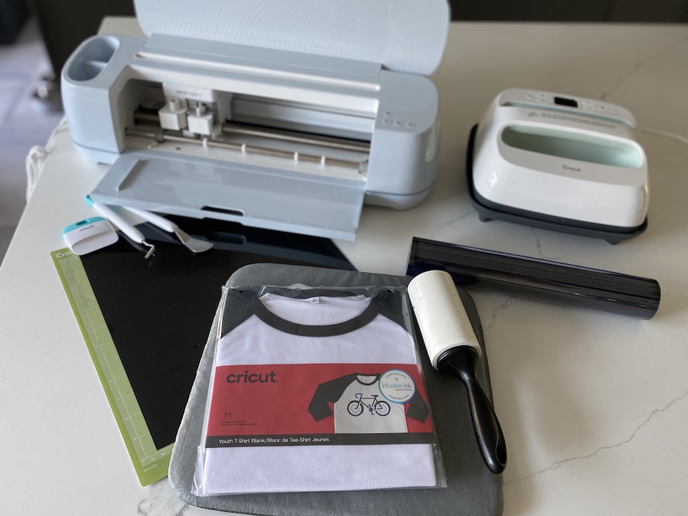 Cricut supplies used to create a back-to-school outfit sit on a granite countertop 