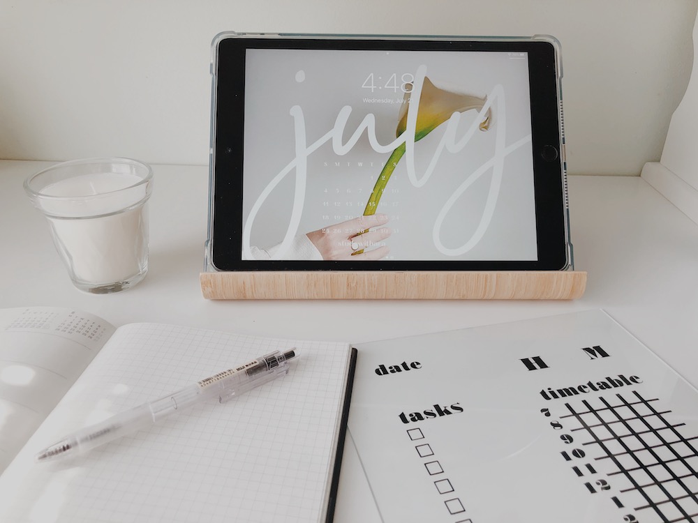 An acrylic study calendar sits on a desktop, functioning as dorm room decor when displayed