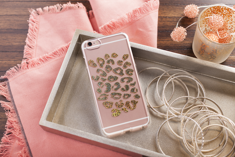 Leopard Print phone case with cord in tray on table on top of pink table runner