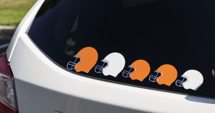 orange and white football helmet decals on car window