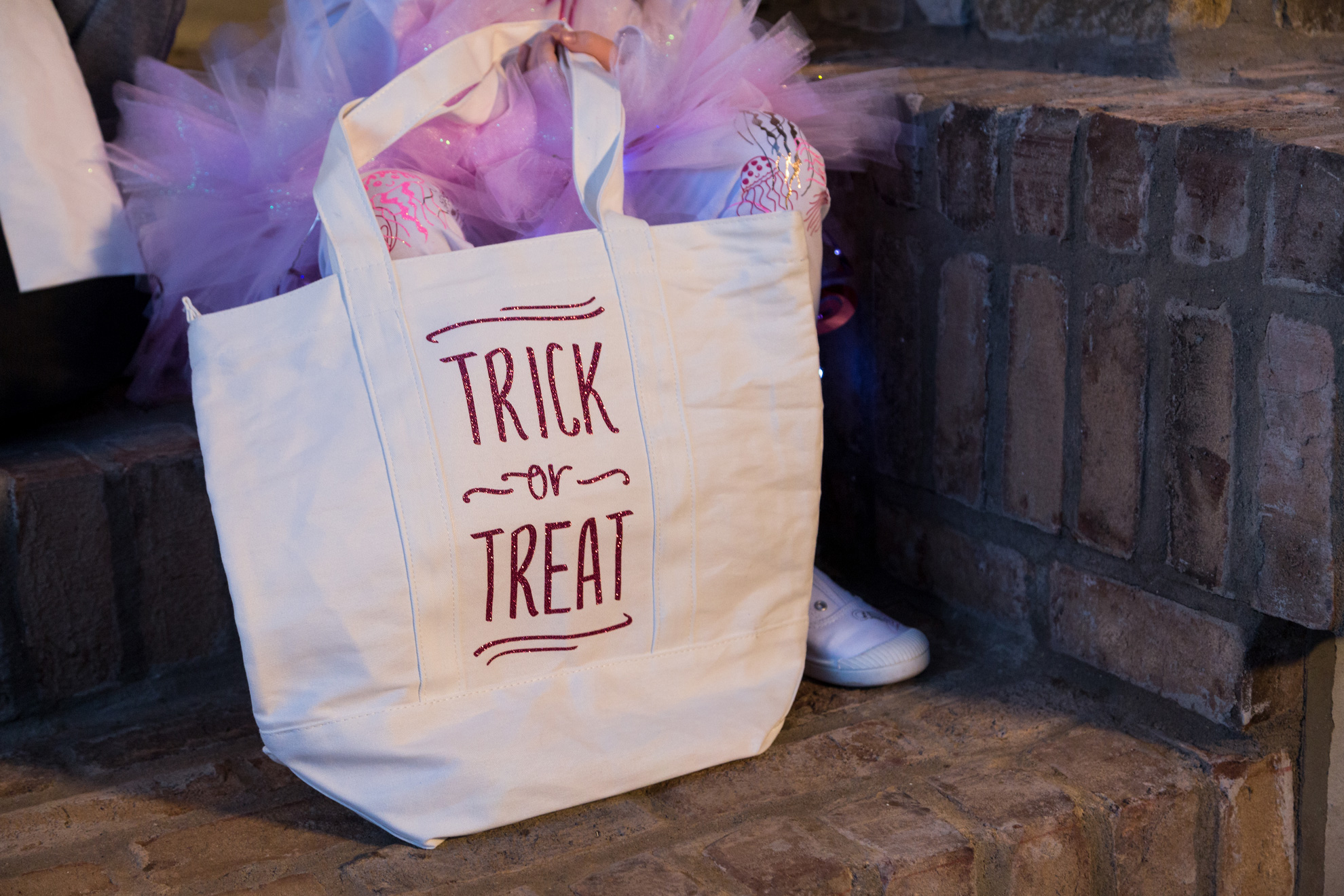 kid with trick-or-treat bags